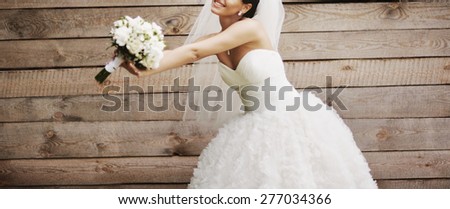 Wedding picture of happy bride against wooden background. 