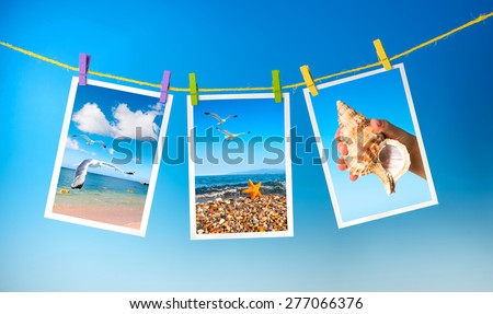 Sea and seagull pictures hanging on colorful pegs on blue background, collage