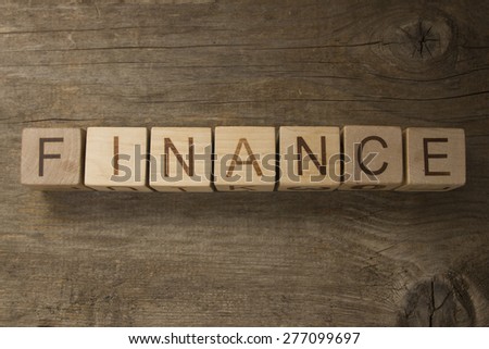 Finance word on a wooden background