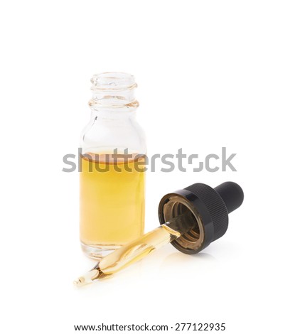 Small medical bottle with a pipette, filled with transparent yellow liquid isolated over the white background