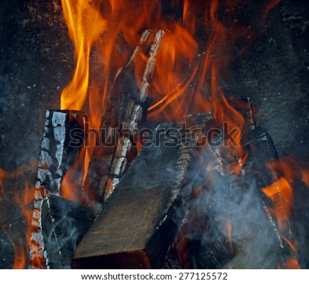 burning firewood in mongale for barbecue outdoors