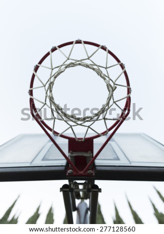 View from Bottom of the Basketball Hoop against White Sky