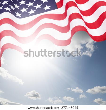 Waving American flag under blue sky