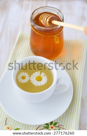 Herbal tea and a jar of honey.