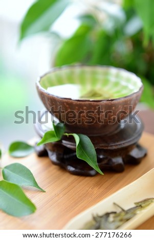 Healthy green tea cup with leaves