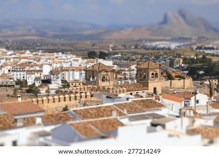Antequera in Andalusia region of Spain. Aerial view of typical Spanish town. Tilt shift style focus with blurred background.