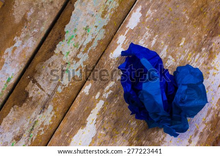 classic blue color crumpled papers on the old boards