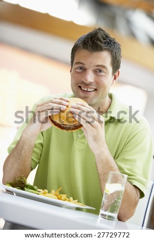 Man Eating Lunch At A Cafe