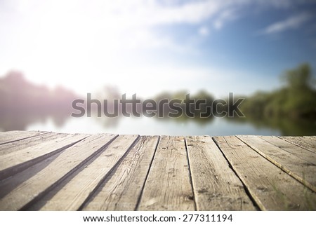 old wooden pier on the  lake. Royalty-Free Stock Photo #277311194