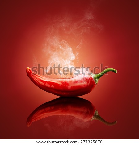 Hot red chili smoking or steaming with reflection Royalty-Free Stock Photo #277325870