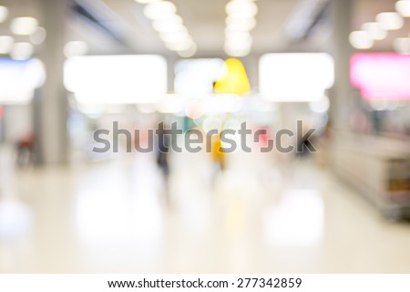 Blur background : Passenger waiting for flight at airport terminal blur background with bokeh light.