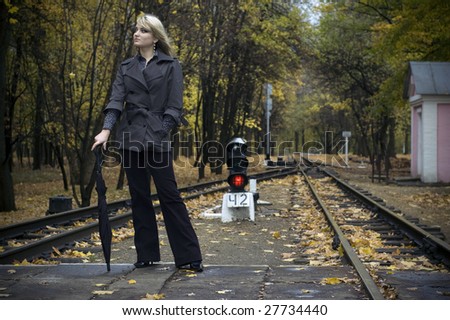 beautiful woman with blonde long hair at autumn park.