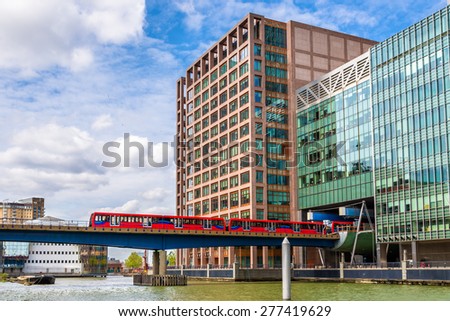 Docklands Light Railway in Canary Wharf business district of London Royalty-Free Stock Photo #277419629