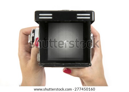 Viewfinder screen on vintage medium format camera with hand holding