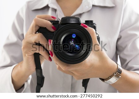 Hand holding black 35mm film camera