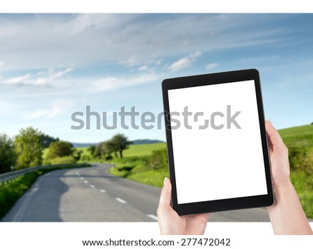 woman uses tablet and road in the background