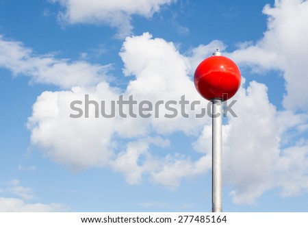 Red sphere on a steel leg resembles a huge lollipop