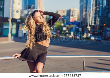 Beautiful stylish young girl on a street 