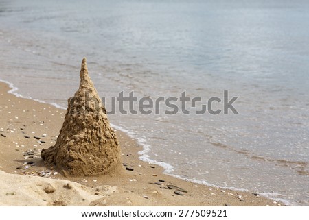 Sand castle, destroyed by the surf. Black Sea coast. Space for text.