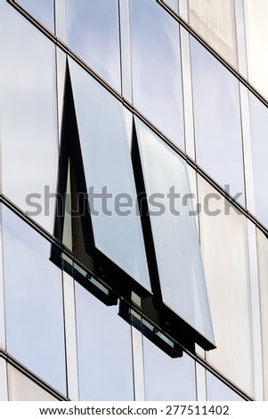 glass facade with opened windows on a modern building