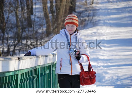 Young photographer on winter background