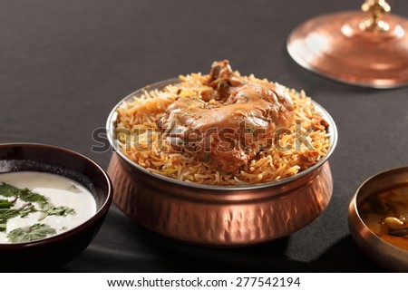 Hyderabadi Biryani is most well-known Non-Vegetarian culinary delights from the famous Hyderabad Cuisine. It is a traditional dish made using Basmati rice, goat meat and various other exotic spices. Royalty-Free Stock Photo #277542194
