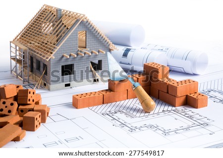 house in construction - project with brick and blueprint Royalty-Free Stock Photo #277549817