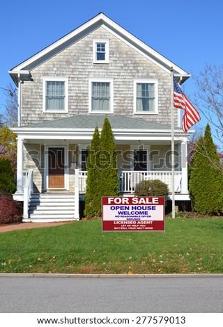 Real estate for sale open house welcome sign American flag pole Beautiful Gable style Suburban Home Sunny Autumn clear blue sky day residential neighborhood USA