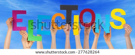 Many Caucasian People And Hands Holding Colorful Letters Or Characters Building The English Word Elections On Blue Sky