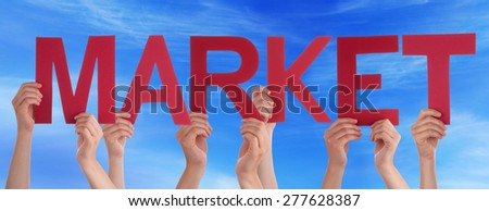 Many Caucasian People And Hands Holding Red Straight Letters Or Characters Building The English Word Market On Blue Sky