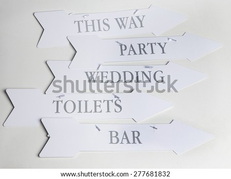White arrow paper shape signs for parties