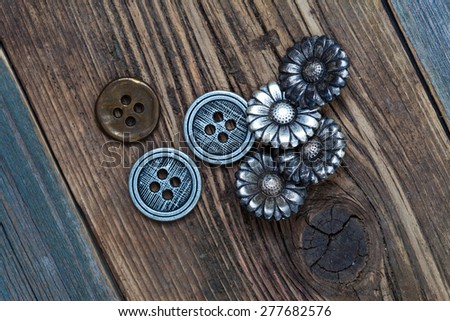 set of vintage buttons on wooden boards aged antique table