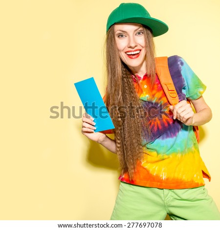  Happy hipster woman tourist with backpack and boarding pass over bright yellow background