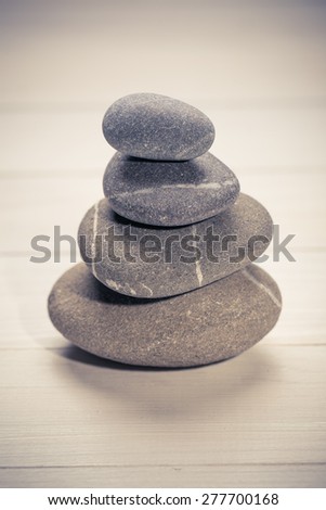 Stacked stones on a  natural wooden background