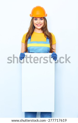 Smiling woman builder coverall dressed holding big board for advertising sign. White Sign board.