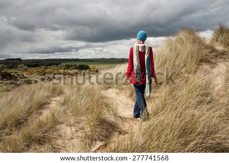 Picture of a woman standing in the sand dunes