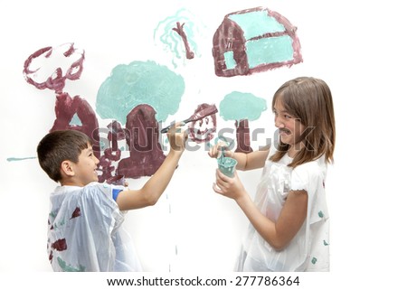 Siblings playing while painting