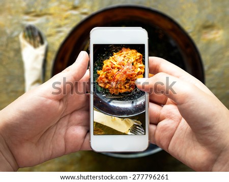 Taking photo of food with smartphone , mobile photographer 