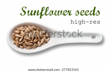 Peeled sunflower seeds in white porcelain spoon / high resolution product photography of seed in white porcelain spoon over white background with place for your text