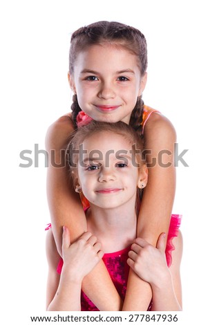 Portrait of two cheerful young girs are standing together. Isolated on the white background