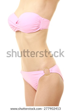 Body of young woman in a pink bikini