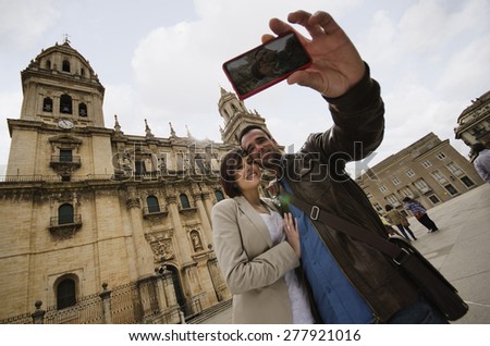 tourist couple taking selfie at jaen cathedral in europe travel. 