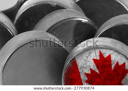Hockey puck with the image of a fragment of the Canadian flag