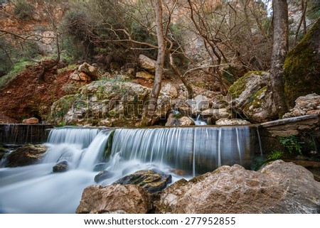 Natural waterfall deep in forest in Greece, long exposure photography