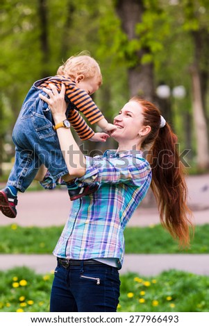 Happy mother with the baby playing outdoor