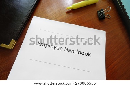 Employee handbook document on an office desk                                Royalty-Free Stock Photo #278006555