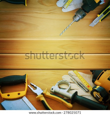 Set of tools over a wood panel with space for text