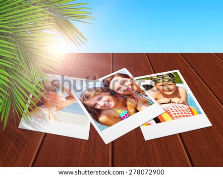 vacation photos with smiling people lying on wooden desk with