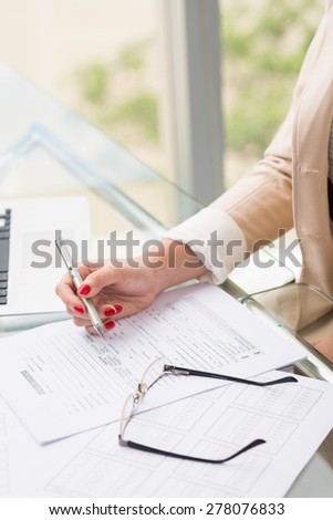 Close-up image of woman filling car accident questionnaire