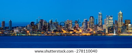Panoramic view of Seattle skylines in blue hour from Alki Beach, West Seattle, Washington, USA.